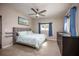 Cozy bedroom with a ceiling fan, blue accents, and comfortable carpeting at 605 Oranole Rd, Maitland, FL 32751