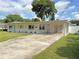 Charming single story home with covered car port and long driveway leading to a large front yard at 605 Oranole Rd, Maitland, FL 32751