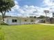 Well-maintained home featuring a lush green lawn, tidy landscaping, and a convenient covered carport at 605 Oranole Rd, Maitland, FL 32751