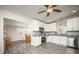 Open kitchen with white cabinets, stainless appliances, and an adjacent dining area at 605 Oranole Rd, Maitland, FL 32751