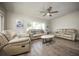 Cozy living room featuring hardwood floors, neutral walls, a ceiling fan, and lots of natural light at 605 Oranole Rd, Maitland, FL 32751