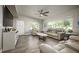 Bright living room with hardwood floors, neutral walls, a ceiling fan, and ample seating for entertaining at 605 Oranole Rd, Maitland, FL 32751