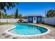 Refreshing pool with blue shed, surrounded by a paver patio and green lawn at 605 Oranole Rd, Maitland, FL 32751