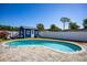Backyard view of the pool and blue shed behind with outdoor seating under a clear blue sky at 605 Oranole Rd, Maitland, FL 32751