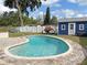 Backyard oasis with a sparkling in-ground pool, blue shed, and cozy outdoor seating area at 605 Oranole Rd, Maitland, FL 32751