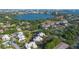 An aerial view of multiple residences near a lake with the city skyline in the distance and lots of green landscape at 7021 Della Dr # 52, Orlando, FL 32819