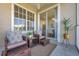 Inviting screened balcony with stylish wicker seating, decorative plants, and view of an airy and bright indoor dining area at 7021 Della Dr # 52, Orlando, FL 32819