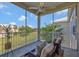 Relaxing screened balcony with comfortable seating and a ceiling fan overlooking a well-maintained lawn at 7021 Della Dr # 52, Orlando, FL 32819