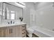 Bathroom with a light wood cabinets, quartz countertops, and a shower-tub combo at 7021 Della Dr # 52, Orlando, FL 32819