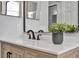 Bathroom with a wood vanity, white countertop, modern fixtures, and a large mirror at 7021 Della Dr # 52, Orlando, FL 32819