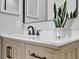 Modern bathroom with a black faucet, light wood cabinets and quartz countertops at 7021 Della Dr # 52, Orlando, FL 32819