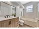 Bathroom features wood cabinets, a large mirror, a soaking tub, and a separate glass-enclosed shower at 7021 Della Dr # 52, Orlando, FL 32819