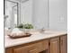 Bright bathroom with a white countertop, light wood cabinets, and a large mirror at 7021 Della Dr # 52, Orlando, FL 32819