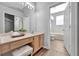 Bathroom with wood cabinets, double sinks, vanity, and open doorway to a separate tub and toilet area at 7021 Della Dr # 52, Orlando, FL 32819