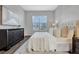 Inviting bedroom with a large window, white linens, a modern dresser, and wood-look flooring at 7021 Della Dr # 52, Orlando, FL 32819
