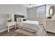 Bedroom with a gray accent wall, modern furniture, and plenty of natural light at 7021 Della Dr # 52, Orlando, FL 32819