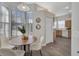 Bright dining area with a round table, white chairs, large windows, and an adjacent kitchen at 7021 Della Dr # 52, Orlando, FL 32819