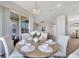 Bright dining area featuring modern chandelier, backyard access, and seating for six at 7021 Della Dr # 52, Orlando, FL 32819