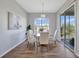 Cozy dining area featuring modern chandelier, backyard view, and seating for five at 7021 Della Dr # 52, Orlando, FL 32819
