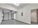 Bright garage with a clean, painted floor, white walls, and a functional garage door and door leading to inside of house at 7021 Della Dr # 52, Orlando, FL 32819