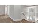Neutral hallway leading to the staircase with a decorative window feature at 7021 Della Dr # 52, Orlando, FL 32819