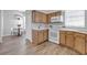 Bright kitchen featuring white appliances, wood cabinetry, and a dining nook at 7021 Della Dr # 52, Orlando, FL 32819