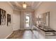 Elegant entryway featuring tile flooring, a mirrored console table, and a view of the landscaped front yard at 796 Mocking Jay Ln, St Cloud, FL 34771