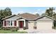 Charming single-story home with stone accents, neutral colors, and a well-manicured lawn in a sunny location at 796 Mocking Jay Ln, St Cloud, FL 34771