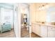 Well-lit bathroom features a vanity with cabinets and drawers, along with a shower and tub combo at 8044 Dreamsicle Dr, Kissimmee, FL 34747