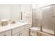 Clean bathroom with single sink vanity and tiled shower with glass door in neutral decor at 8044 Dreamsicle Dr, Kissimmee, FL 34747