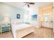 Bright bedroom featuring a comfortable queen bed, ceiling fan, and ensuite bathroom with double vanity at 8044 Dreamsicle Dr, Kissimmee, FL 34747