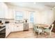 Bright kitchen features white cabinets, stainless steel appliances, and a dining table at 8044 Dreamsicle Dr, Kissimmee, FL 34747