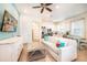 Bright living room with a white sofa, a glass coffee table, and views into the kitchen at 8044 Dreamsicle Dr, Kissimmee, FL 34747