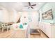 Open-concept living room with stairs, a dining table, and a white sofa and entertainment console at 8044 Dreamsicle Dr, Kissimmee, FL 34747