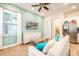 Cozy living room features a mounted TV, white furniture, and lots of natural light at 8044 Dreamsicle Dr, Kissimmee, FL 34747