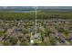 Aerial view of home in a neighborhood with a lake and green space in the distance at 8555 Abbotsbury Dr, Windermere, FL 34786