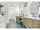 Bright bathroom featuring dual sinks, and shiplap accent wall, complemented by sleek matte black fixtures and hardware at 8555 Abbotsbury Dr, Windermere, FL 34786