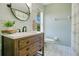 Bright bathroom featuring a wooden vanity, neutral color palette, and decorative floor tiles, creates a relaxing space at 8555 Abbotsbury Dr, Windermere, FL 34786