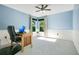 Home office with light blue walls, wainscotting, wooden desk, and windows offering natural light for an efficient workspace at 8555 Abbotsbury Dr, Windermere, FL 34786