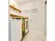 Efficient laundry room with side by side washer and dryer and custom shelving at 8555 Abbotsbury Dr, Windermere, FL 34786