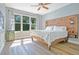 A beautifully lit main bedroom features a wooden headboard and light wood grain floors, creating a warm, inviting atmosphere at 8555 Abbotsbury Dr, Windermere, FL 34786