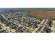 Scenic aerial view of a neighborhood with a beautiful pond and lush greenery in the distance at 8565 Tallfield Ave # 1, Orlando, FL 32832