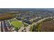 Extensive neighborhood aerial view with houses, manicured lawns, and winding roads in a scenic setting at 8565 Tallfield Ave # 1, Orlando, FL 32832