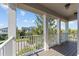 Relaxing balcony with white columns and railings, offering neighborhood views at 8565 Tallfield Ave # 1, Orlando, FL 32832