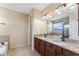Bathroom featuring double sinks, granite countertops, a bathtub, and natural lighting at 8565 Tallfield Ave # 1, Orlando, FL 32832