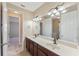 Bathroom features dual sinks, a large mirror, ample counter space, and updated fixtures at 8565 Tallfield Ave # 1, Orlando, FL 32832