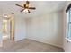 Spacious bedroom features carpet flooring, a ceiling fan, and natural light streaming in through the window at 8565 Tallfield Ave # 1, Orlando, FL 32832