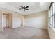 Large bedroom boasting neutral walls, plush carpeting, and a ceiling fan at 8565 Tallfield Ave # 1, Orlando, FL 32832