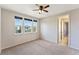 Comfortable bedroom featuring carpet flooring, a ceiling fan, multiple windows, and neutral paint at 8565 Tallfield Ave # 1, Orlando, FL 32832
