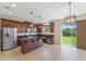 Modern kitchen with stainless steel appliances, granite countertops, large island, and sliding glass doors to backyard at 8565 Tallfield Ave # 1, Orlando, FL 32832
